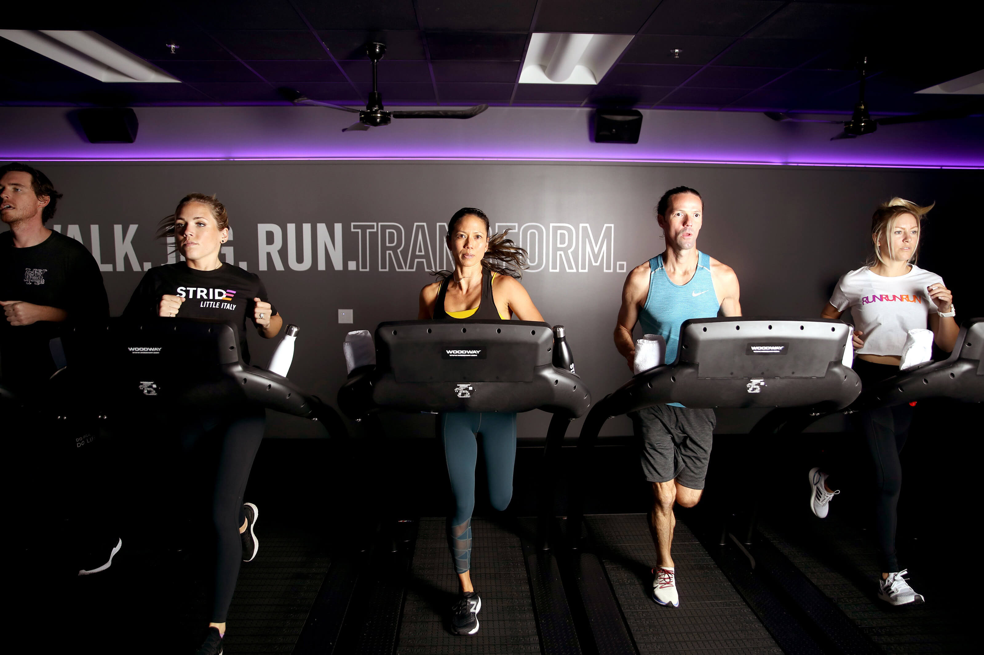 Group running on treadmills at STRIDE